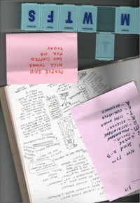 a notebook with sticky notes on it