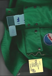 a green jacket with tags on it