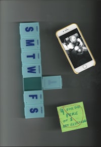 a phone with a note on it next to a set of scrabble blocks