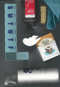 a tray with various items on it, including a bottle of water and a sponge