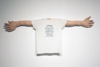 a white t - shirt hanging on a wall