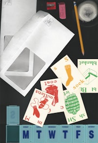 a set of envelopes, stamps, and other items on a table