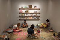 a group of people sitting on the floor in a room