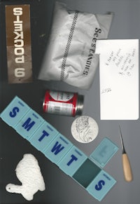 a group of items including a pen, a pencil, and a piece of paper