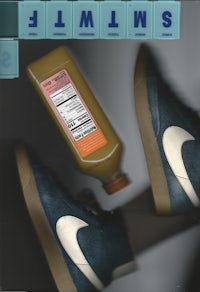 a bottle of juice next to a pair of sneakers