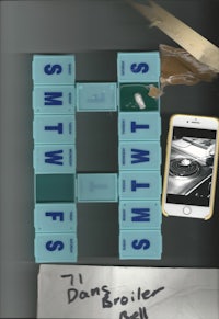 a game of scrabble on a table with a phone next to it